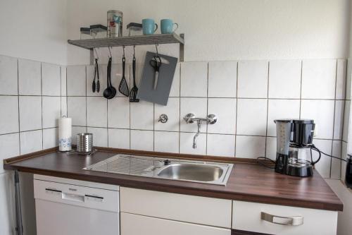 a kitchen with a sink and a counter top at Ferienwohnung Bärbel in Essen