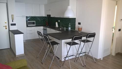 a kitchen with a counter and chairs in a room at Camogli Golfo Paradiso la casa del Comandante in Camogli