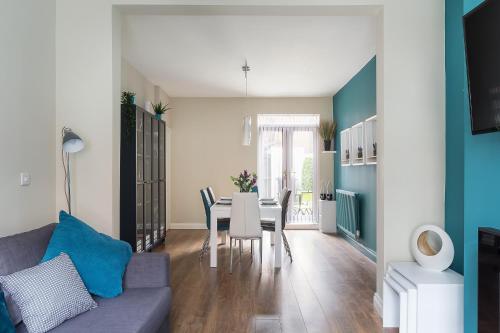 a living room with a couch and a table with chairs at Bishop's Rest in Bishop Auckland