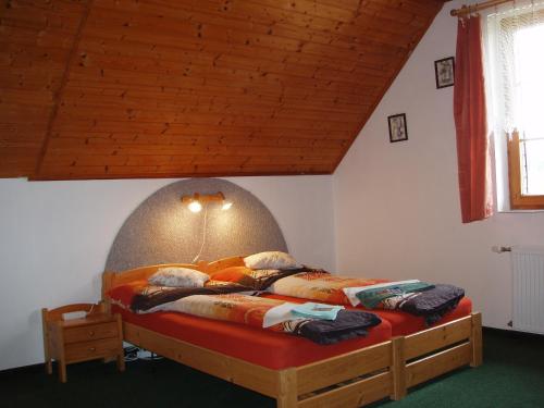 a bedroom with a large bed with an egg head at Pension Jitka in Harrachov