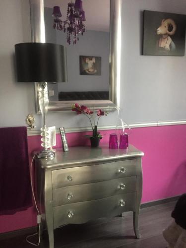 a room with a dresser with a mirror and a lamp at Lyon City Home's Bed & Breakfast in Villeurbanne