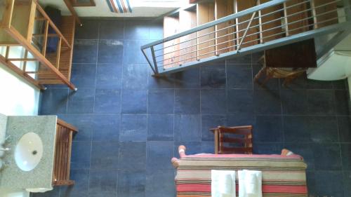 a bathroom with a staircase and a chair and a towel at Hotel La Cautiva de Ramirez in La Paz