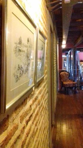 a hallway with a painting on a wall at Hotel La Cautiva de Ramirez in La Paz