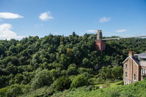 an old house on a hill with a bridge in the background at Avon Gorge by Hotel du Vin in Bristol