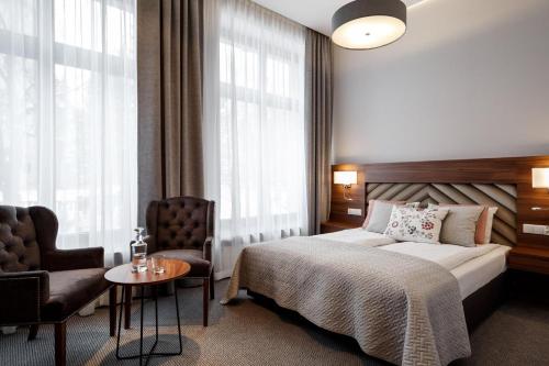 Un pat sau paturi într-o cameră la Villa Vita Krupówki