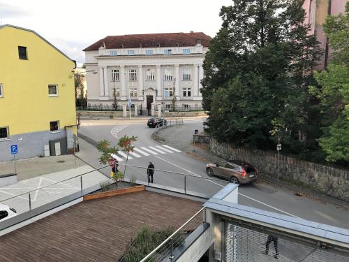 a view of a city street with a car on the road at Penzión v Inom Svete in Žilina