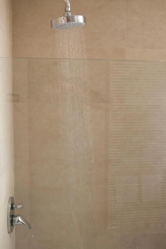 a shower with water coming out of a glass door at Ca' Pozzo Inn in Venice