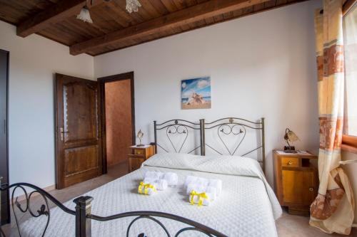 ein Schlafzimmer mit einem Bett mit zwei Teddybären darauf in der Unterkunft Casa Vacanza il Mandorlo in Domusnovas