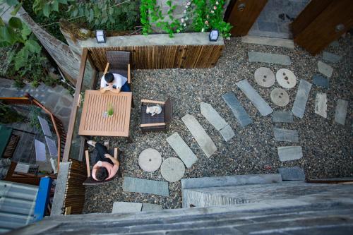 an overhead view of a dog sitting in a wooden box at Wang Jiang Reclusive Boutique Inn in Fenghuang