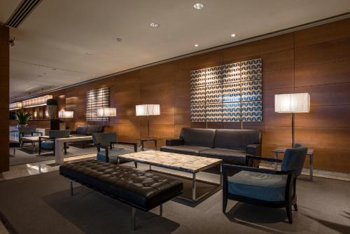 a lobby with a couch and tables and chairs at Ergife Palace Hotel in Rome