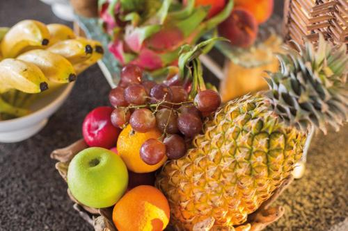 a bunch of fruit in a basket on a table at Drift Thelu Veliga Retreat in Dhangethi