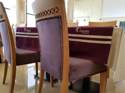 a pair of purple chairs in a room at Hotel Ildis in Iaşi