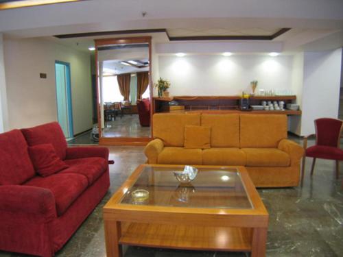 a living room with a couch and a coffee table at Diana Hotel in Chios