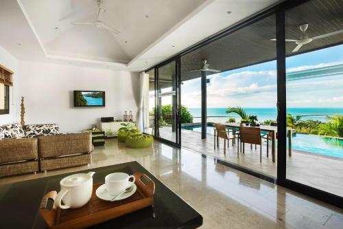 an open living room with a view of the ocean at Villa Baan Saitara in Lamai