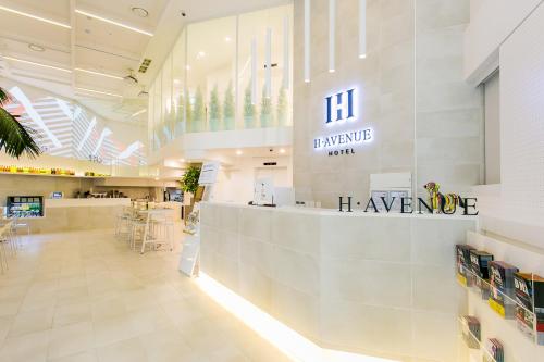 a lobby of a pharmacy with a sign on the wall at H Avenue Hotel Idae Shinchon in Seoul