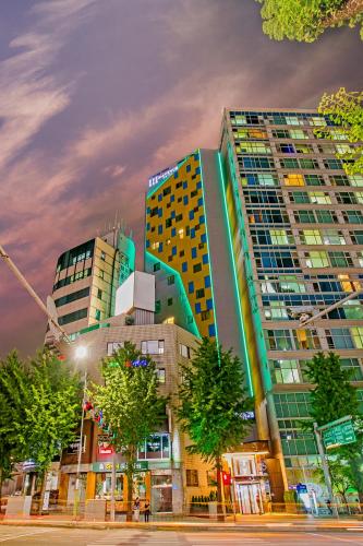 a group of tall buildings in a city at H Avenue Hotel Idae Shinchon in Seoul