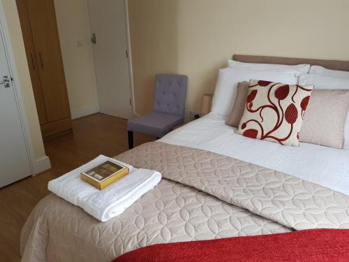a bedroom with a bed with a tray on it at Kathleen House Plus in Enfield