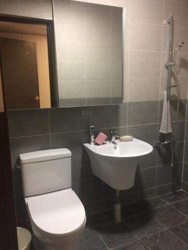 a bathroom with a white toilet and a sink at Guest House Dalggume in Mokpo