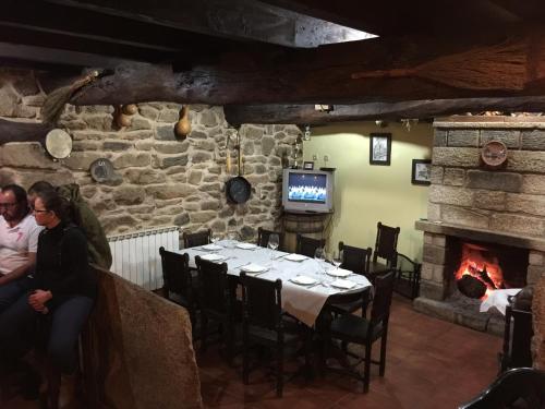 a dining room with a table and a fireplace at Casaquina in La Mezquita