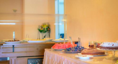 a buffet with cakes and other desserts on a table at Limnionas Bay Village Hotel in Marathokampos
