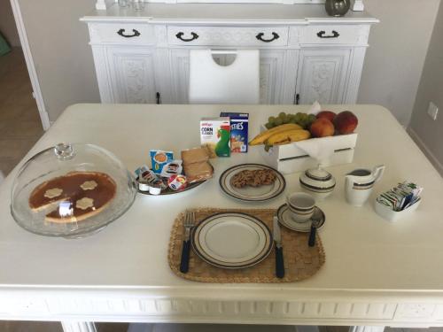 a table with plates and other food on it at B&b note di mare in Imperia