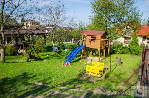 a playground with a slide and a swing at Zajazd Zacisze in Rymanów-Zdrój