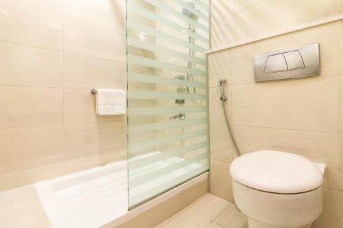 a bathroom with a toilet and a shower at Citymax Hotel Al Barsha at the Mall in Dubai