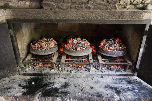 four pizzas are cooking in a stone oven at Počitniška hiša Lazar in Kobarid