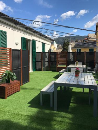a patio with a picnic table on the grass at Affittacamere Il Borgo in Levanto