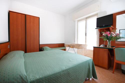 A bed or beds in a room at Albergo Adriana