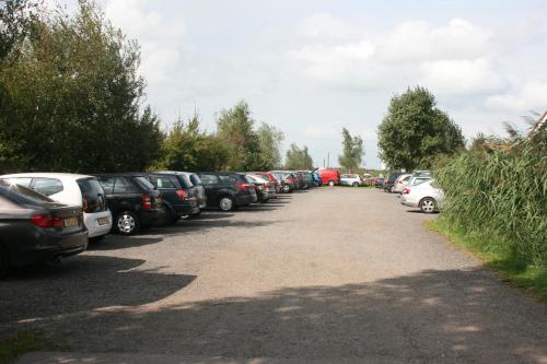 a row of cars parked in a parking lot at Rufus aan het water in Broek