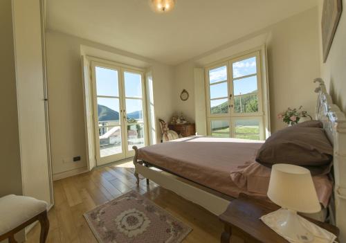 sypialnia z łóżkiem i 2 oknami w obiekcie Villa Caiano - Luxury In Tuscany w mieście Londa