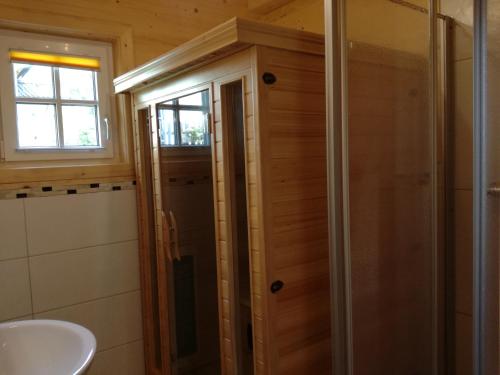 a bathroom with a shower and a sink at Stoffis Hütten in Tauplitz