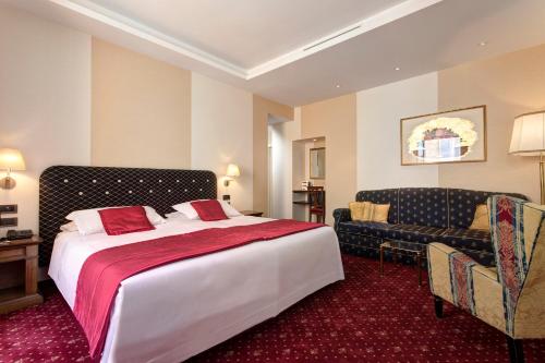 a hotel room with a bed and a couch at Hotel Nazionale in Rome