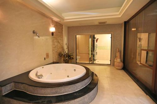 a large bathroom with a tub in the middle at Hua Jia Motel in Tainan