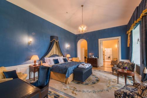 a bedroom with blue walls and a bed and a couch at Kernu Manor Hotel & SPA in Kernu