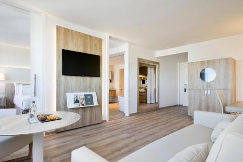 a living room filled with furniture and a tv at Melia Madrid Princesa in Madrid