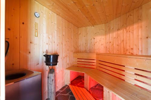 a wooden sauna with a bench and a sink at Haus Angelika in Vandans
