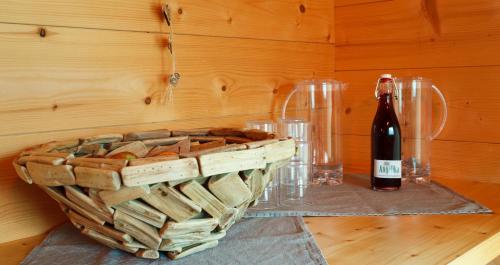 a bottle of wine and a basket of bread at Haus Angelika in Vandans