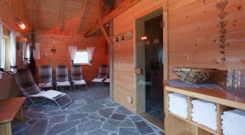 a room with chairs in a wooden cabin at Haus Angelika in Vandans