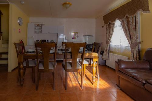 a kitchen and dining room with a table and chairs at Cabañas Última Esperanza in Puerto Natales