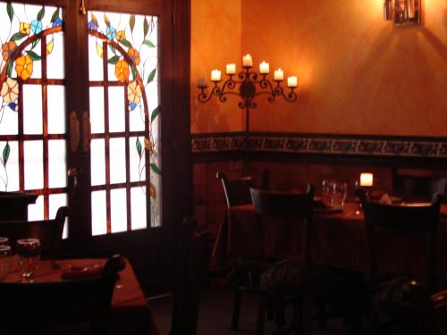 a dining room with tables and chairs and a window at Hotel Principe in Tuluá