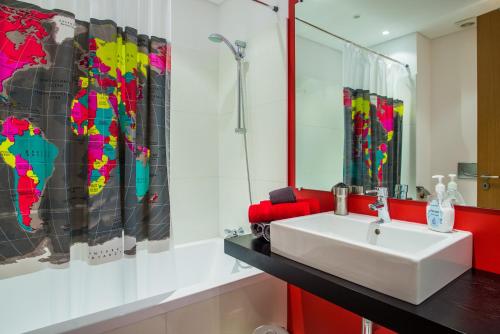 a bathroom with a white sink and a map on the wall at The Bay View - by LovelyStay in Funchal