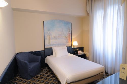 Postel nebo postele na pokoji v ubytování iH Hotels Milano Ambasciatori