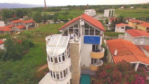 a building with a sign on the side of it at Apartments and bungalows vila Dalibor in Nin