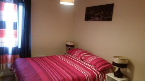 ポーツマスにあるMed cozy flatのベッドルーム1室(ピンクのシーツが敷かれたベッド1台、窓付)