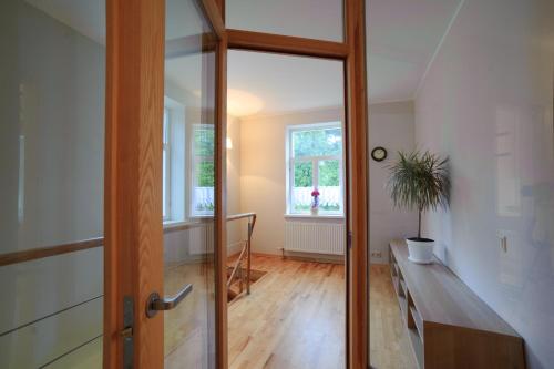 a hallway with a wooden door and a window at Amber Coast & Sea in Jūrmala