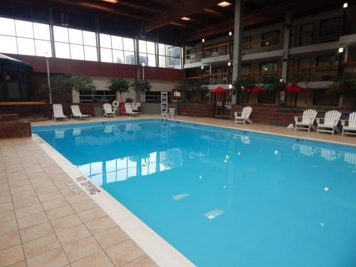 a large swimming pool in a large building at Ramada by Wyndham Beaver Falls in Beaver Falls