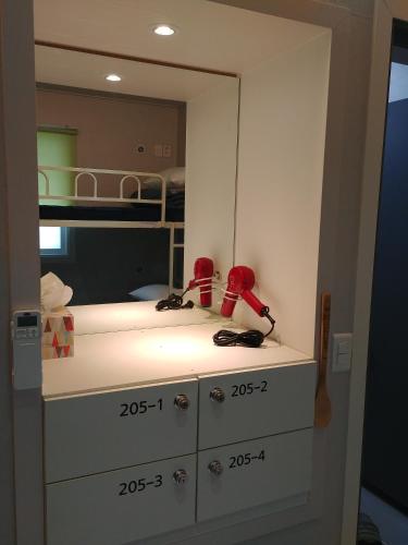 a bathroom with a sink and a mirror at Bomgoro Guesthouse in Daegu