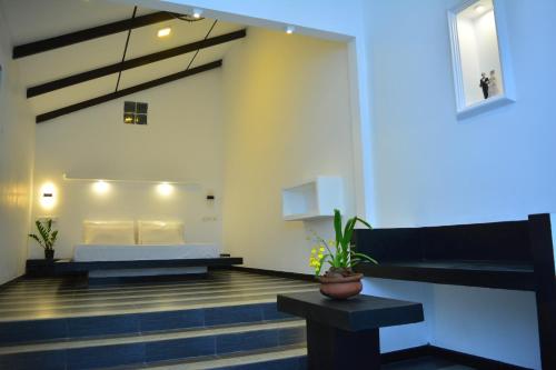 a hotel room with a bed and a couch at Midigama Holiday Inn in Midigama